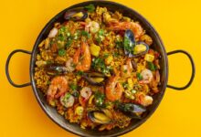 Paella de frutos do mar em fundo amarelo, imagem de abertura das tendências do foodservice